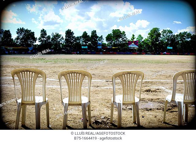 Row of chairs in a football field in Tibetan camp Mundgod, Karnataka, India, Asia