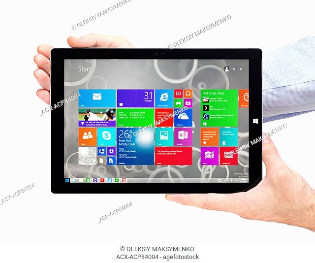 Person hands holding Microsoft Surface Pro 3 tablet computer isolated on white background