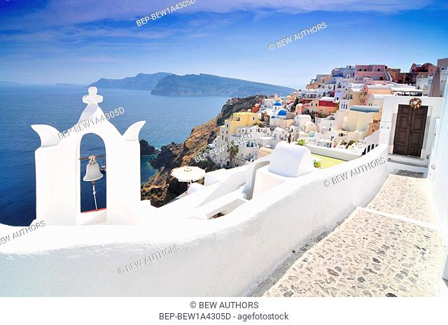 Santorini landscape with white greek bell tower and sea in the background - Oia Town, Santorini Island, Cyclades, Greece