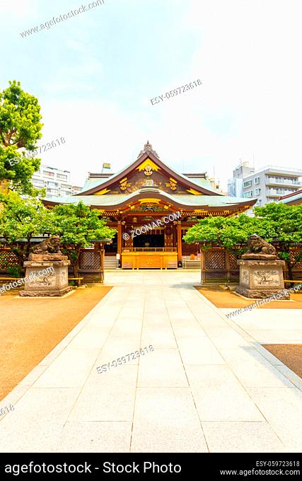 Centered front entrance to Yushima Tenman-Gu Shinto Shrine on a sunny summer day in Tokyo, Japan. Vertical