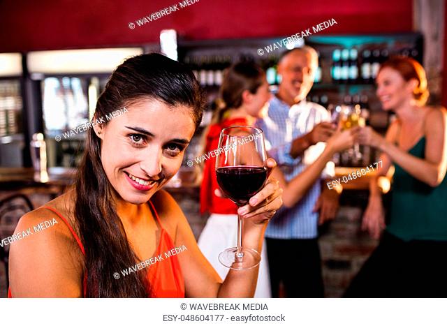 Woman enjoying red wine in night club