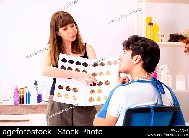 Young attracrive man visiting female barber