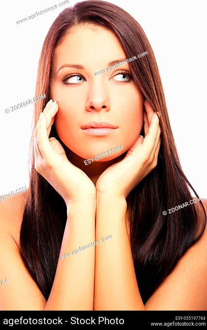 Young and beautiful woman with long hairs against white background