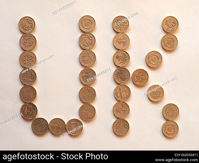UK written with One Pound coins money (GBP), currency of United Kingdom