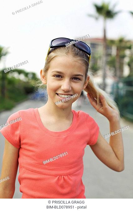Caucasian girl wearing sunglasses