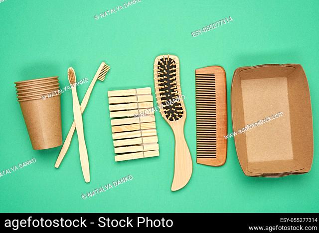 various household items from recyclable raw materials on a green background, top view, zero waste
