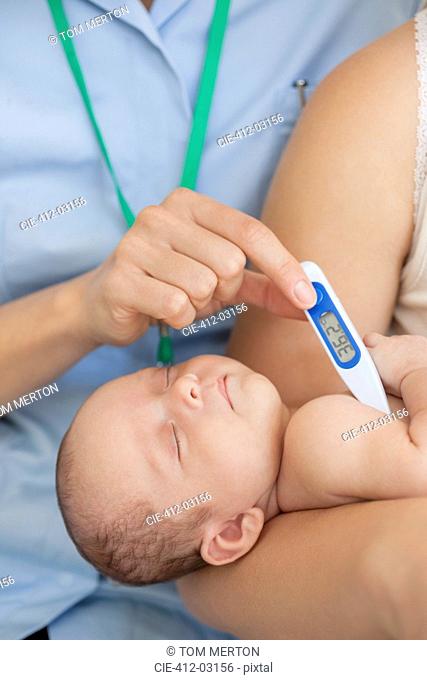 Nurse taking baby's temperature