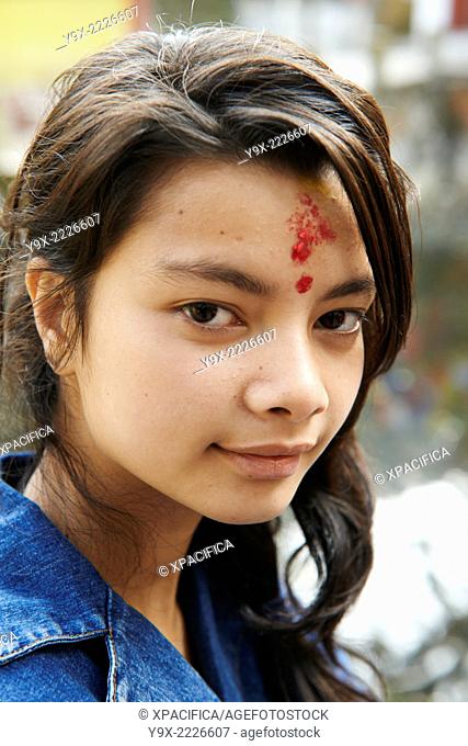 Portrait of a teenage girl with a Hindu tilaka marking