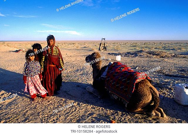 Near Nefta Tunisia Berber Woman And Children And Camel