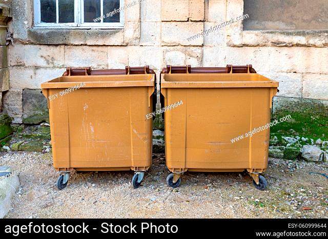 Two Big Brown Dumpster Recycling Bins at Street