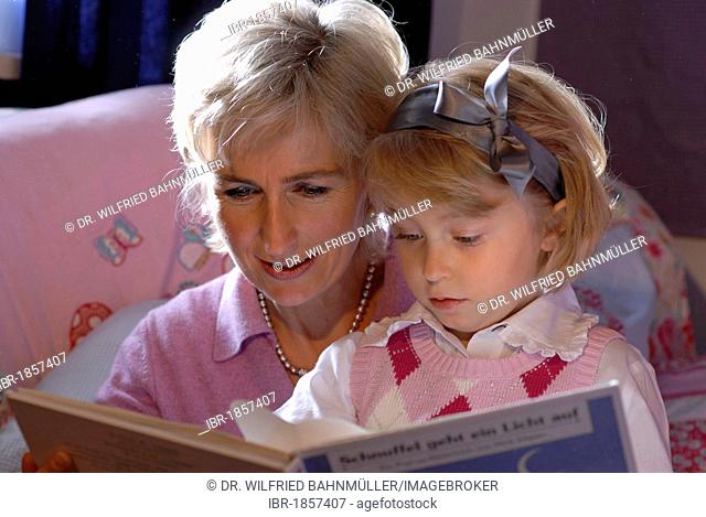 Mother is reading to her daughter