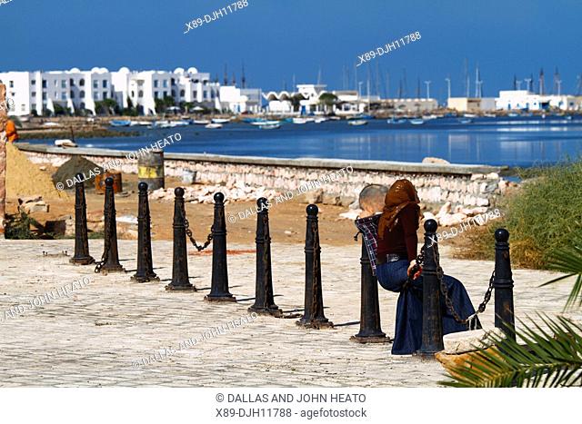 Africa, Tunisia, Djerba Island, Mediterranean Sea, Local Woman Looking Towards Houmt Souk
