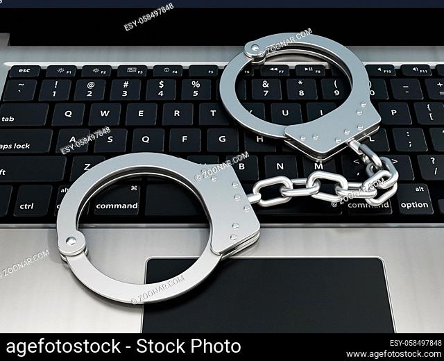 Handcuffs standing on laptop computer keyboard