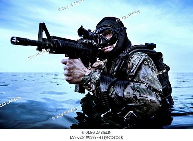 Navy SEAL frogman with complete diving gear and weapons in the water