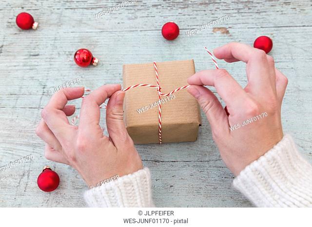 Woman's hands wrapping Christmas present