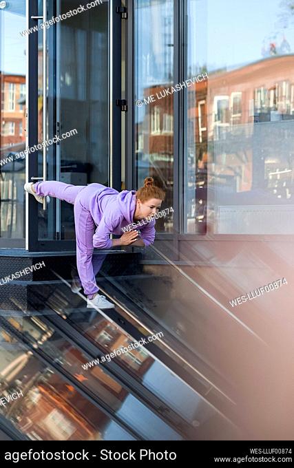Woman doing stretching exercise on staircase