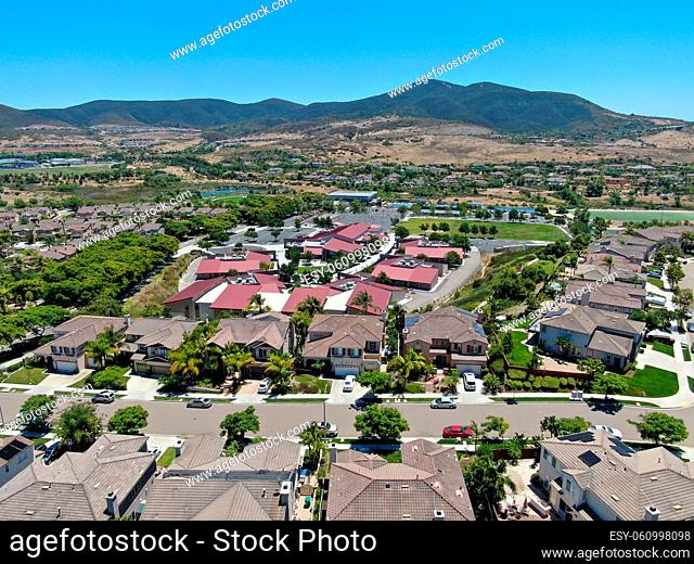 Aerial view of suburban neighborhood with big mansions and mountain on the background in San Diego, California, USA. Aerial view of residential modern...