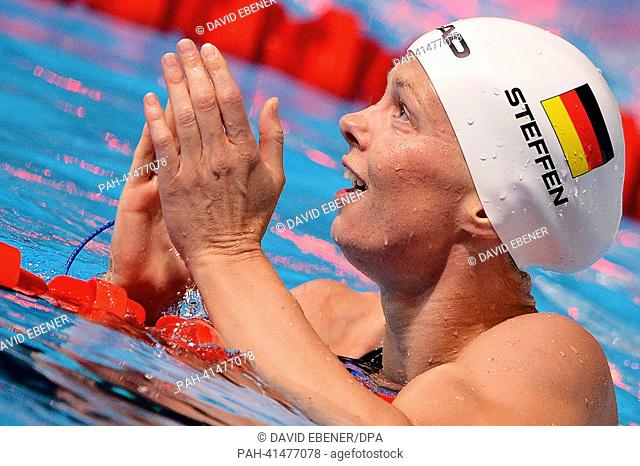 Britta Steffen of Germany claps hands after the women's 100m Freestyle final during the 15th FINA Swimming World Championships at Palau Sant Jordi Arena in...