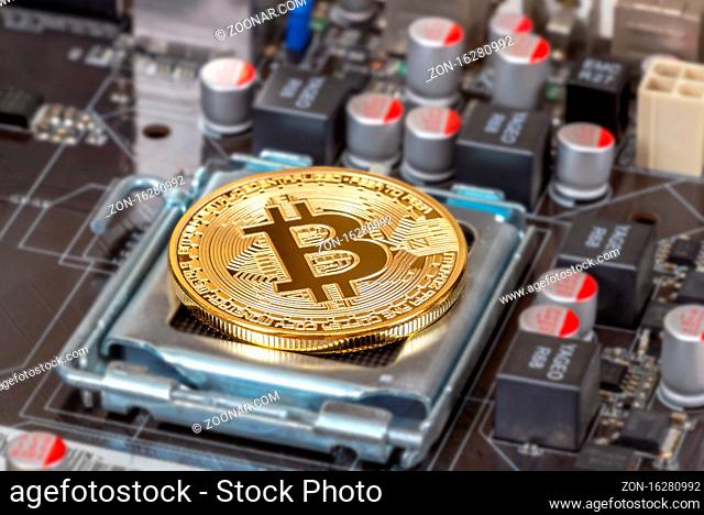 Samara, Russia - December 11, 2017: Cryptocurrency Bitcoin lying over electronic computer component. Business concept of digital money