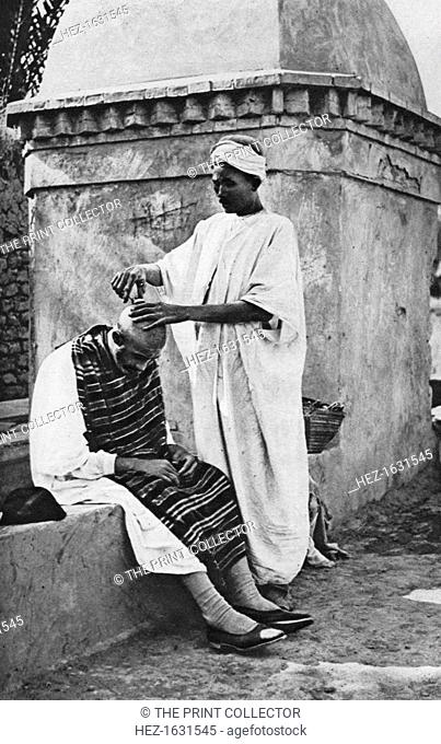 A street barber and his client, Algeria, Africa, 1922. From Peoples of All Nations, Their Life Today and the Story of Their Past