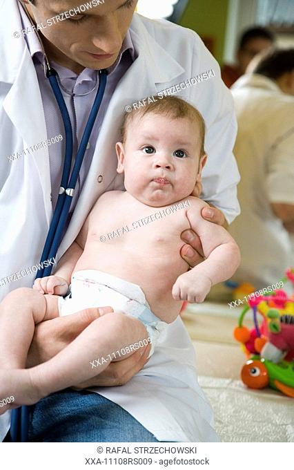 doctor examining†infant