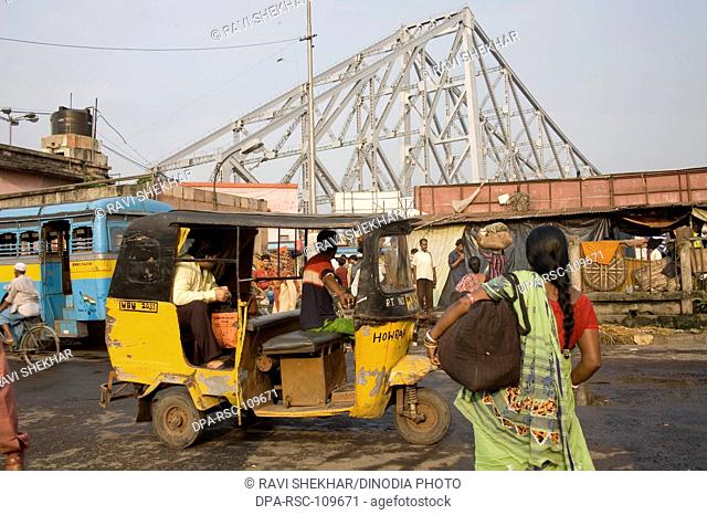 Street transportation ; Howrah Bridge now Rabindra Setu over River Hooghly ; Calcutta Kolkata ; West Bengal ; India