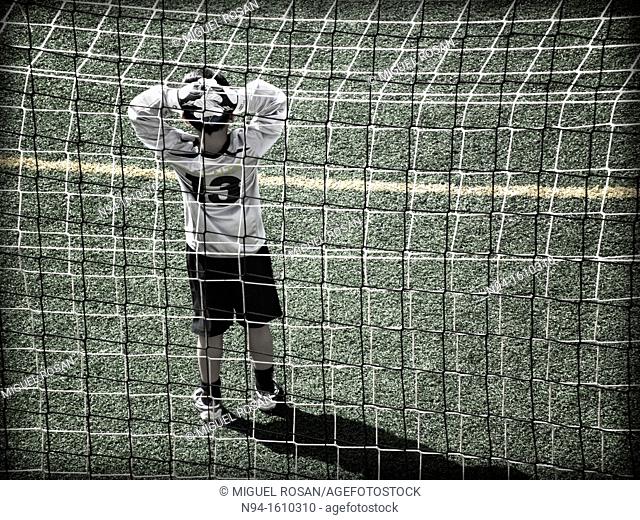 Soccer goalie during a game in a child meeting