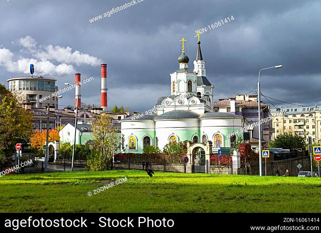 Moscow contrasts - building in the style of constructivism, the smoking chimneys of the power station and the old Orthodox Church next to each other against the...