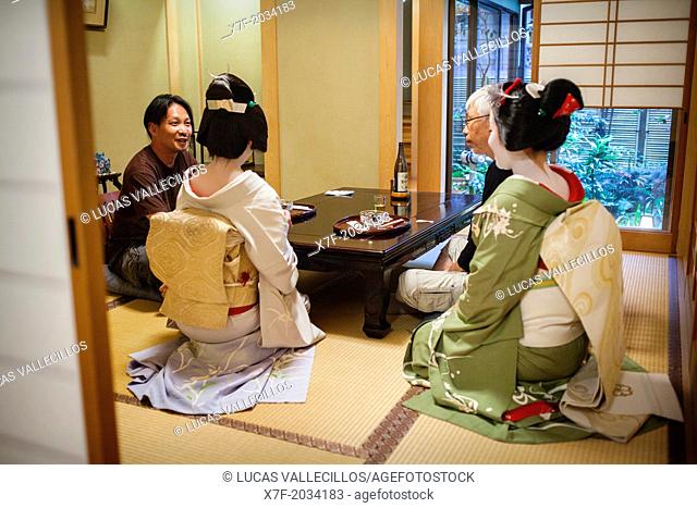 Fukuyu, geisha and Fukukimi, 'maiko' (geisha apprentice) workimg in Miyaki tea house (o-chaia).Geisha's distric of Miyagawacho.Kyoto. Kansai, Japan