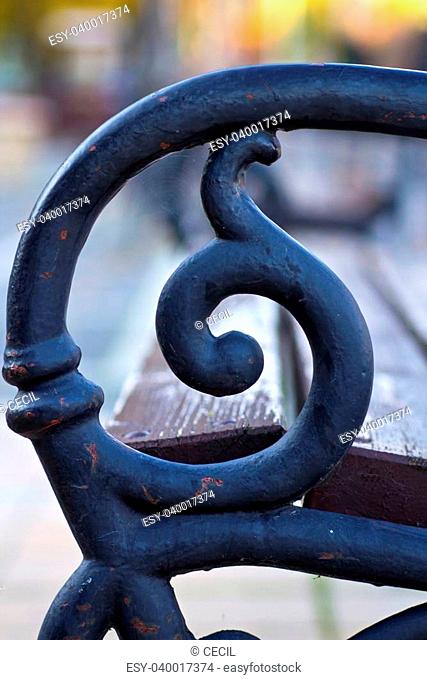 A deatil of a wrought iron bench