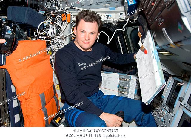 Cosmonaut Roman Romanenko, Expedition 21 flight engineer, occupies the commander's station on the flight deck of space shuttle Atlantis (STS-129) while docked...