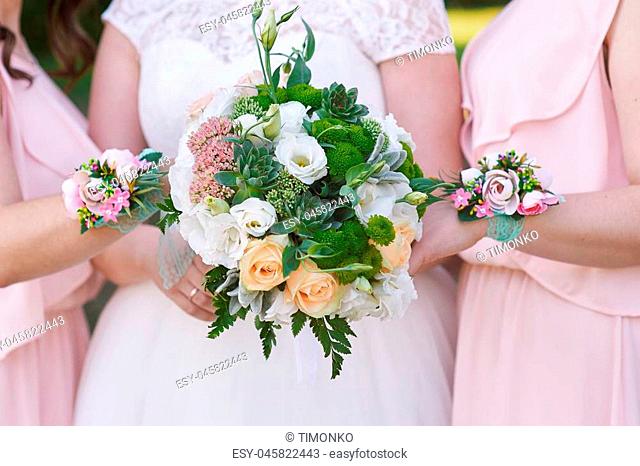 bride with bridesmaids are holding wedding bouquets