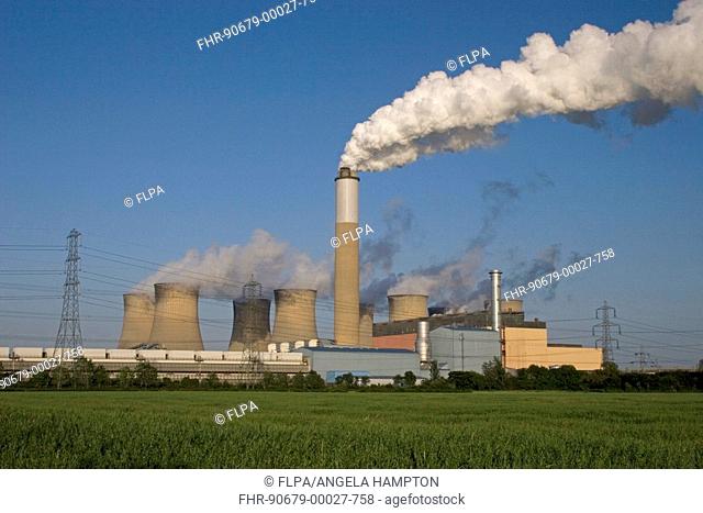 Coal-fired power station, industrial chimneys and cooling towers billowing out smoke and steam, Cottam, Nottinghamshire, England