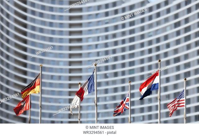 International flags in front of highrise