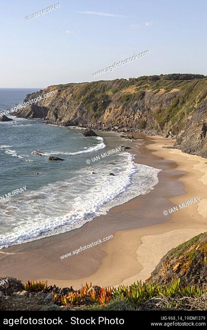 Secluded sandy beach in bay between rocky headlands at Parque Natural do Sudoeste Alentejano e Costa Vicentina, Natural Park