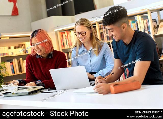 Young people studying in library