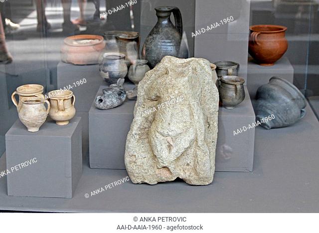 Ancient rock artifact, ceramic clay jars, jugs and pots on display in glass case at the National Archaeological Museum Djerdap, Kladovo, Serbia