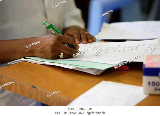 Photo essay in a hospital in Brazzaville, Congo. Doctor filling a medical file