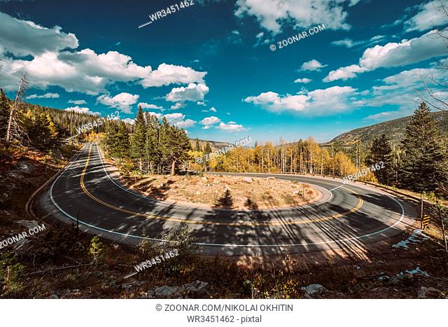 Highway with hairpin turn (switchback) at autumn sunny day in Rocky Mountain National Park. Colorado, USA