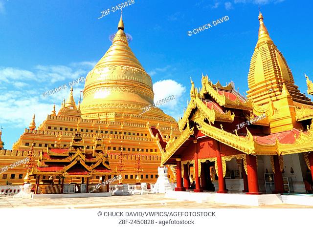 The ornate domes of the shwezigon temple complex in Myanmar, set against a blue sky