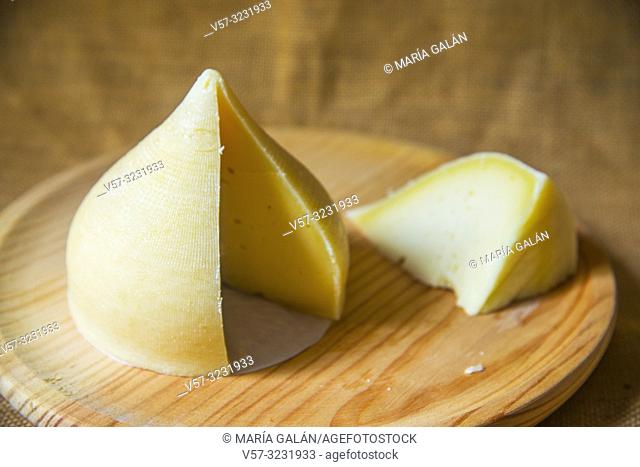 Tetilla cheese cut in pieces on wooden dish. Galicia, Spain