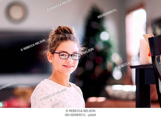 Girl with Christmas tree in background