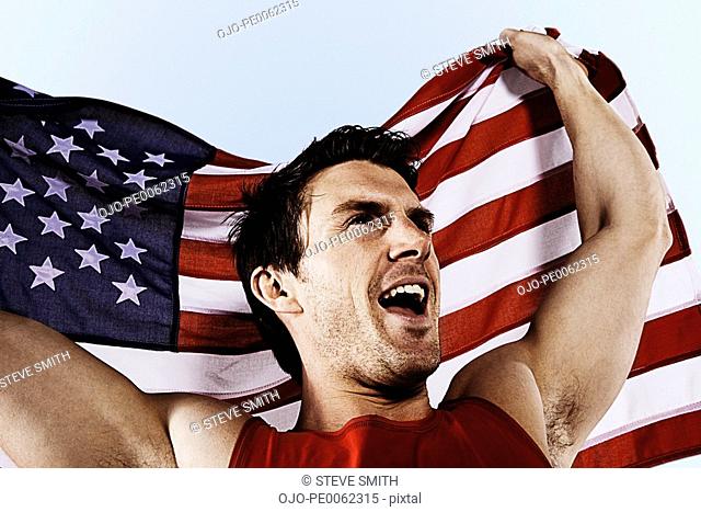 Athlete with American flag smiling and proud