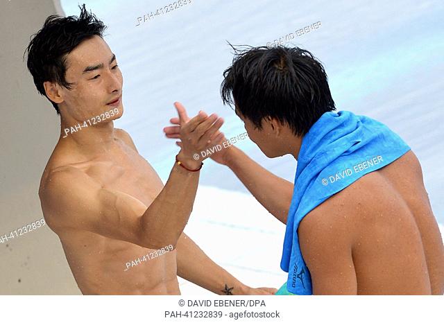 Gold medalists Kai Qin and Chong He of China react after winning the men's 3m Synchro Springboard diving final of the 15th FINA Swimming World Championships at...