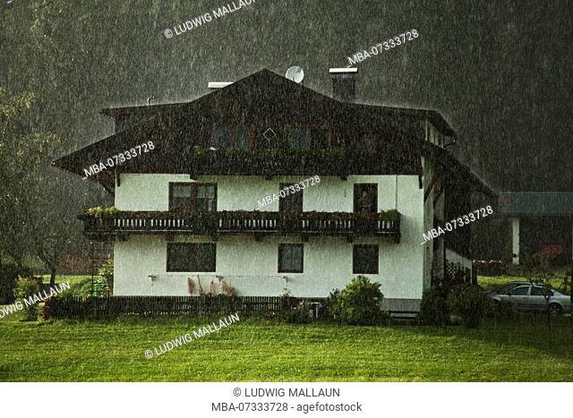 Austria, Tyrol, Obsteig, farm in heavy rain