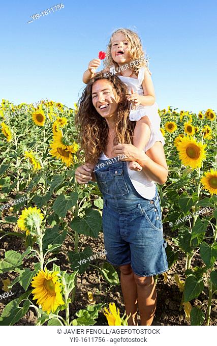 mother and daughter in a field of sunflowers