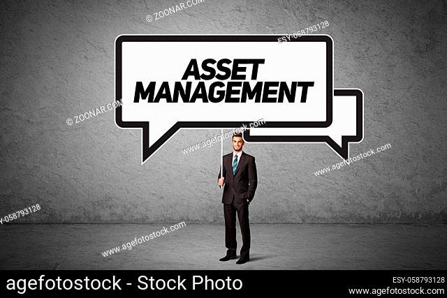 Young business person in casual holding road sign with ASSET MANAGEMENT inscription, new business idea concept