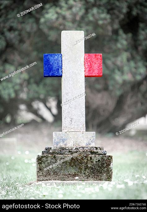 Old weathered gravestone in the cemetery - France