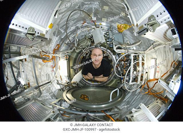 A fisheye lens attached to an electronic still camera was used to capture this image of NASA astronaut Don Pettit, Expedition 31 flight engineer
