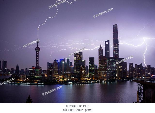 Elevated cityscape with lightning striking oriental pearl tower at night, Shanghai, China